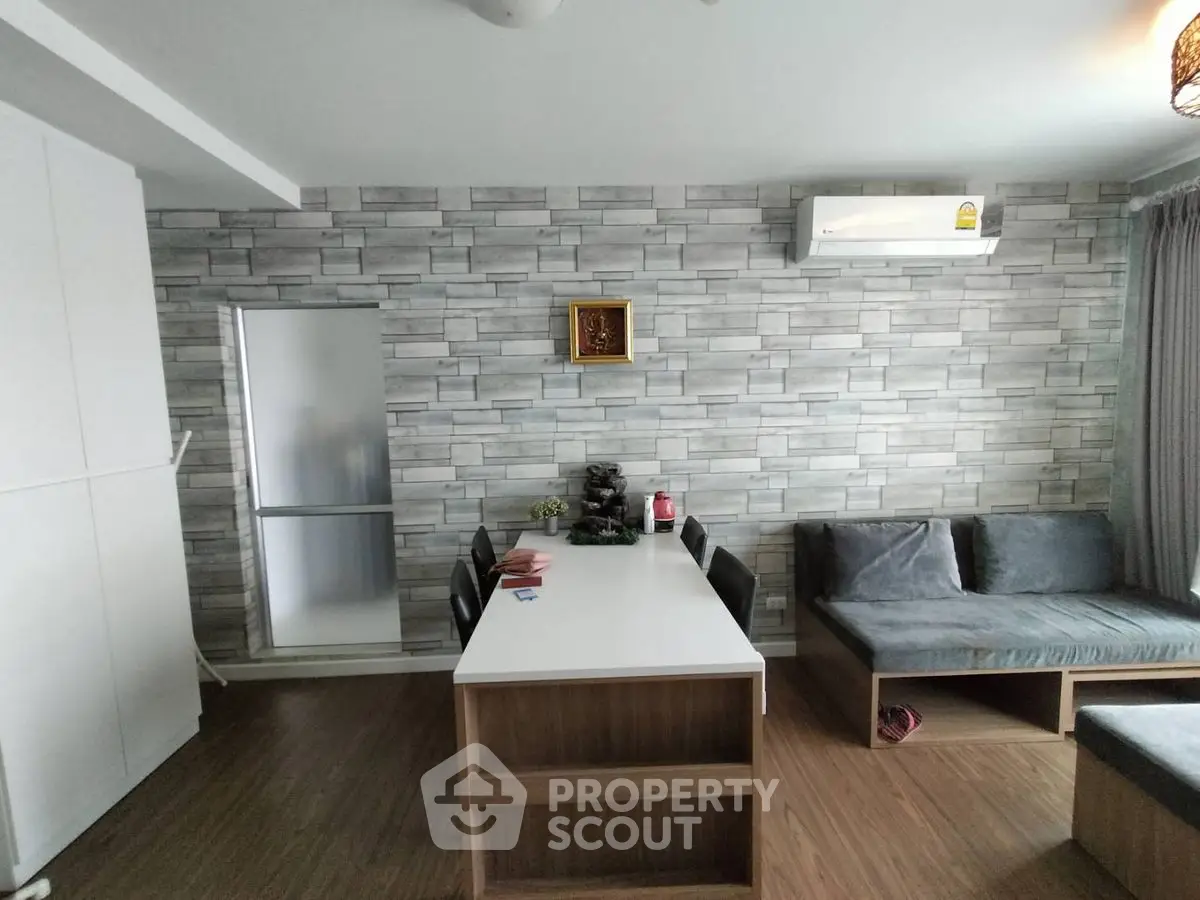 Modern living room with stylish stone accent wall and sleek furniture