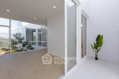 Spacious modern living room with large windows and balcony access