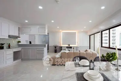 Spacious open-plan living room with modern kitchen and elegant dining area, featuring large windows and stylish decor.