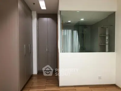 Modern interior with glass-walled shower and sleek storage solutions