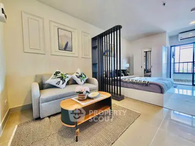 Modern studio apartment with stylish decor and open layout, featuring cozy living area and bedroom separation.