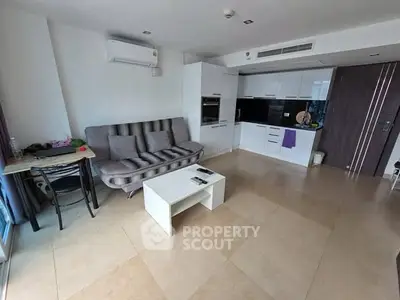 Modern living room with open kitchen layout and stylish furniture