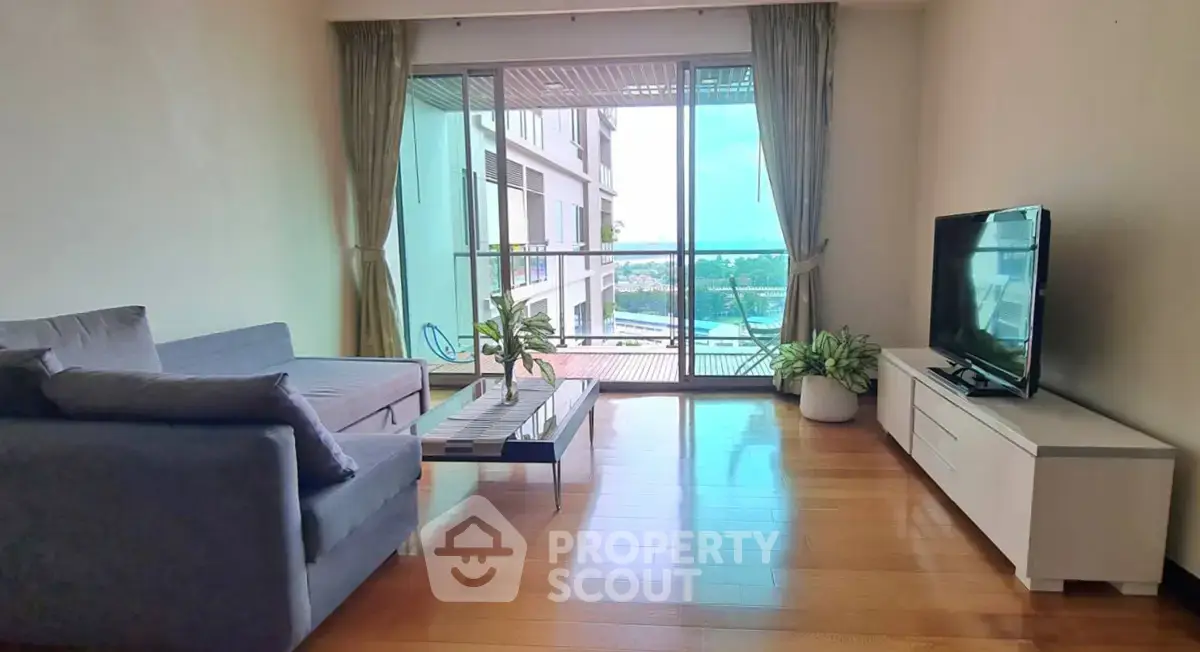 Spacious living room with modern decor and balcony view in a luxury apartment.