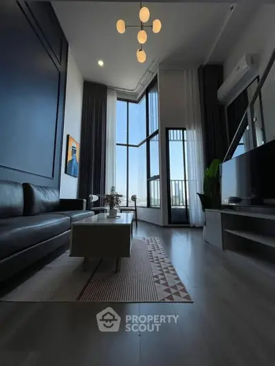 Luxurious high-ceiling living room with modern decor and expansive windows offering stunning views.