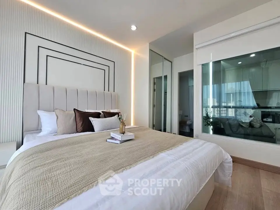 Luxurious modern bedroom with elegant decor and large windows offering natural light.