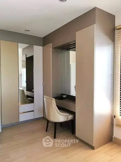 Elegant bedroom with built-in wardrobe and stylish vanity area