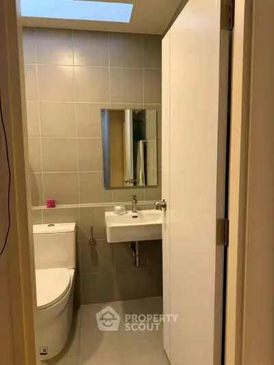 Modern bathroom with sleek fixtures and neutral tiles