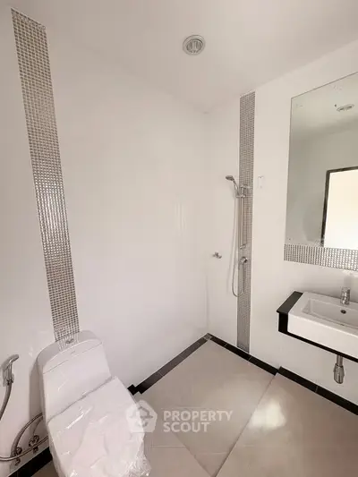 Modern bathroom with sleek fixtures and elegant tile design, perfect for a contemporary home.