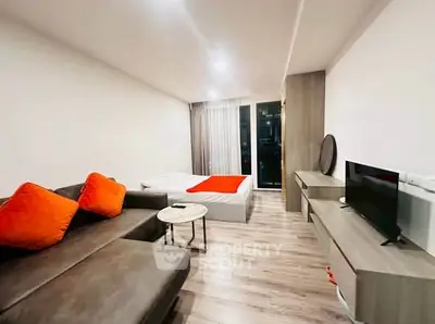 Modern studio apartment with cozy living area and stylish decor