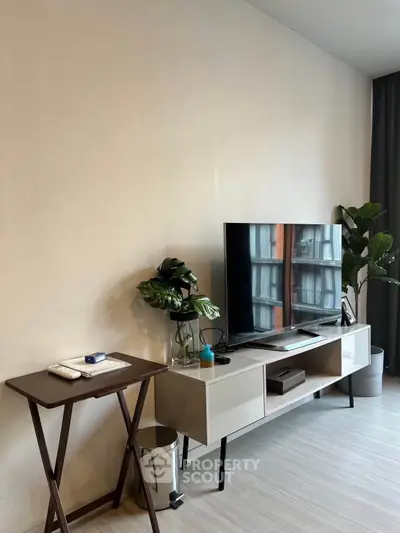 Modern living room with sleek TV stand and indoor plants, perfect for urban living.