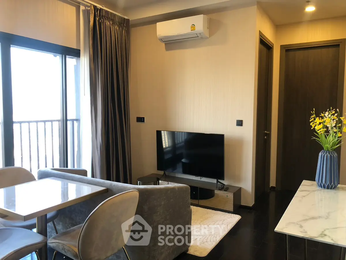 Modern living room with balcony, air conditioning, and stylish decor in a cozy apartment.