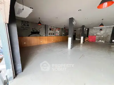 Spacious commercial interior with modern decor and ample lighting, ideal for a trendy business setup.