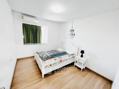 Bright minimalist bedroom with wooden flooring and elegant decor