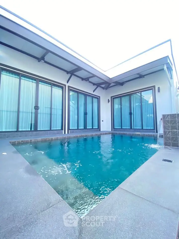 Luxurious private pool surrounded by modern architecture in a serene setting.