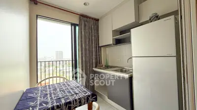 Compact kitchen with balcony view in modern apartment