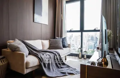 Stylish living room with city view, cozy sofa, and modern decor in high-rise apartment.