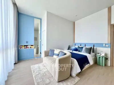 Modern bedroom with stylish decor and cozy seating area