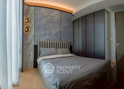 Luxurious modern bedroom with elegant design and stylish lighting fixtures.