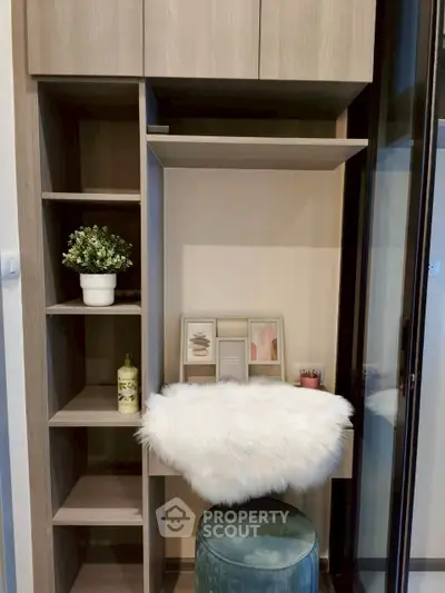 Chic modern study nook with shelving and plush seating in elegant apartment