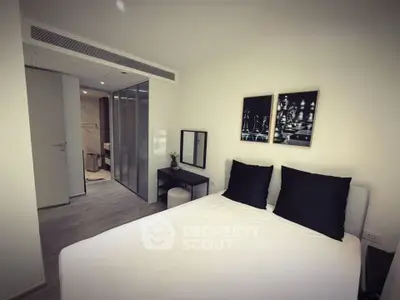 Modern bedroom with ensuite bathroom and stylish decor in a contemporary apartment.