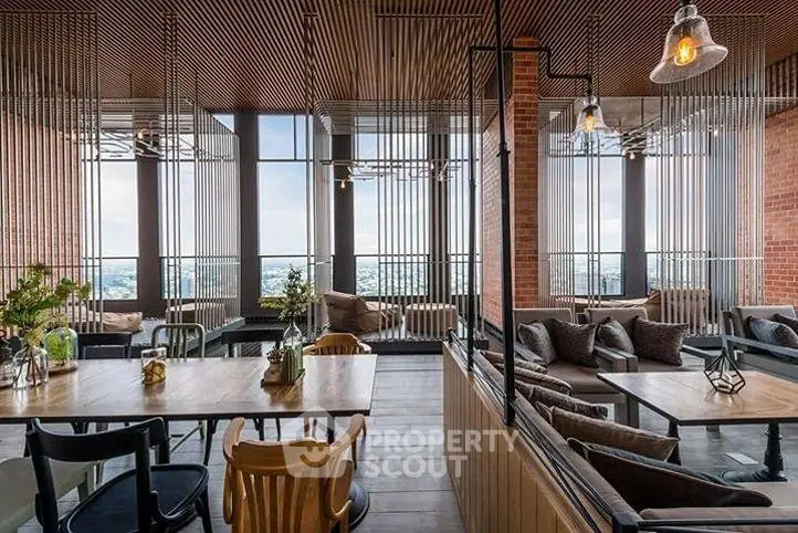 Stylish modern co-working space with panoramic city views and chic interior design.