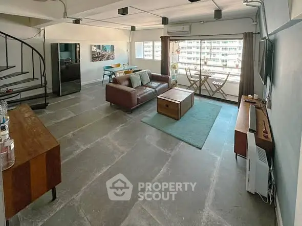 Spacious modern living room with large windows and stylish furniture in urban apartment.