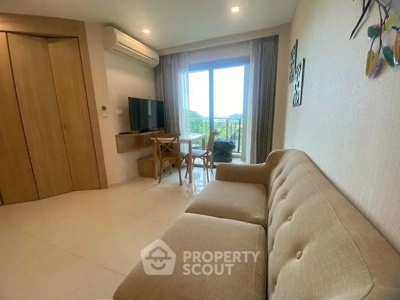 Modern living room with beige sofa and balcony view