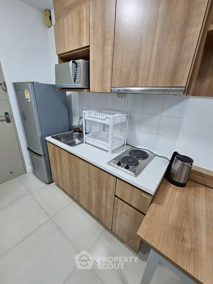 Modern kitchen with wooden cabinets and stainless steel appliances