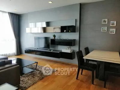 Modern living room with sleek furniture and wall-mounted TV in a stylish apartment.