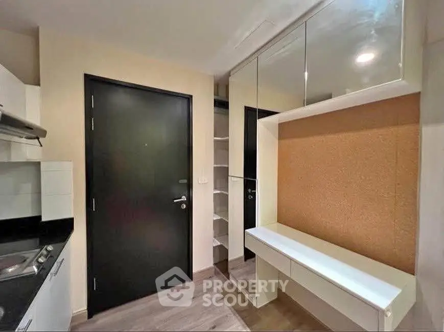 Modern apartment entryway with sleek storage and mirrored accents
