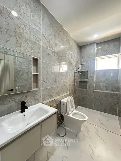 Luxurious modern bathroom with marble tiles and sleek fixtures
