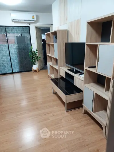 Modern living room with wooden flooring and stylish shelving units