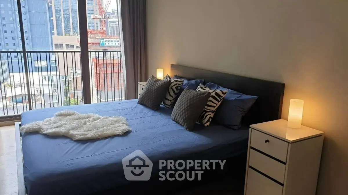 Modern bedroom with city view, stylish decor, and cozy ambiance.