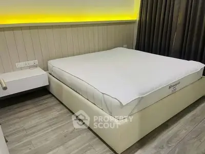 Modern bedroom with sleek design and ambient lighting