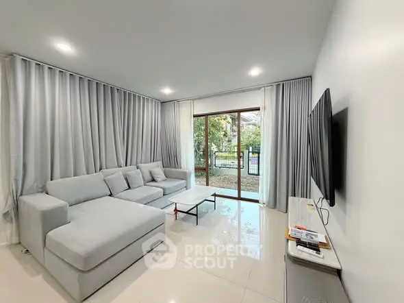 Spacious modern living room with large windows and elegant decor