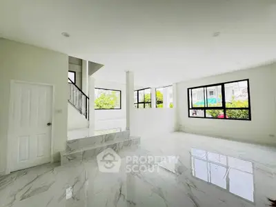 Spacious modern living room with marble flooring and large windows