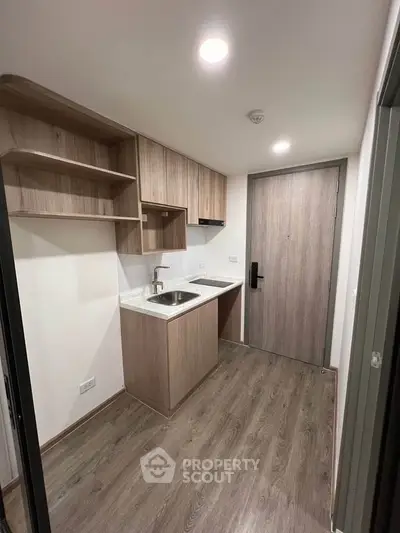 Modern compact kitchen with wooden cabinets and sleek design