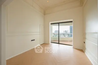 Spacious empty room with parquet flooring and city view balcony, perfect for customization.