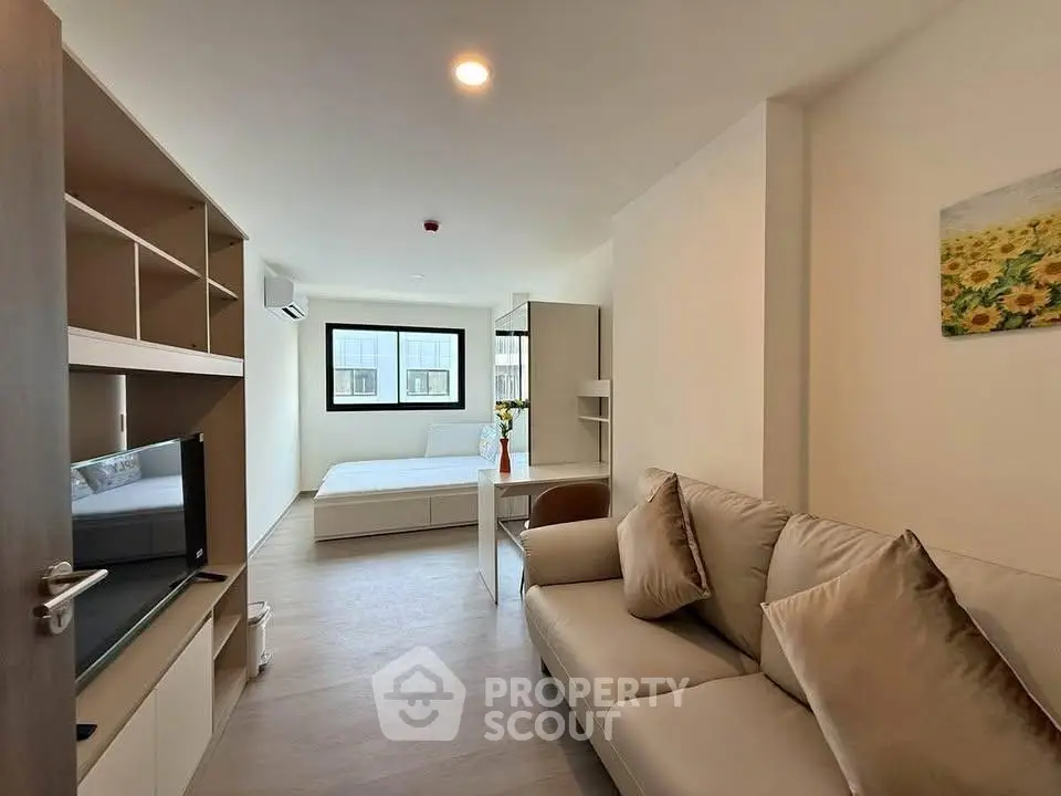 Modern studio apartment with cozy living area and natural light