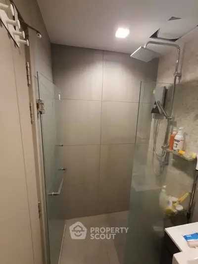 Modern bathroom with glass shower enclosure and sleek fixtures