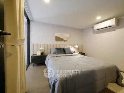 Cozy modern bedroom with stylish decor and air conditioning