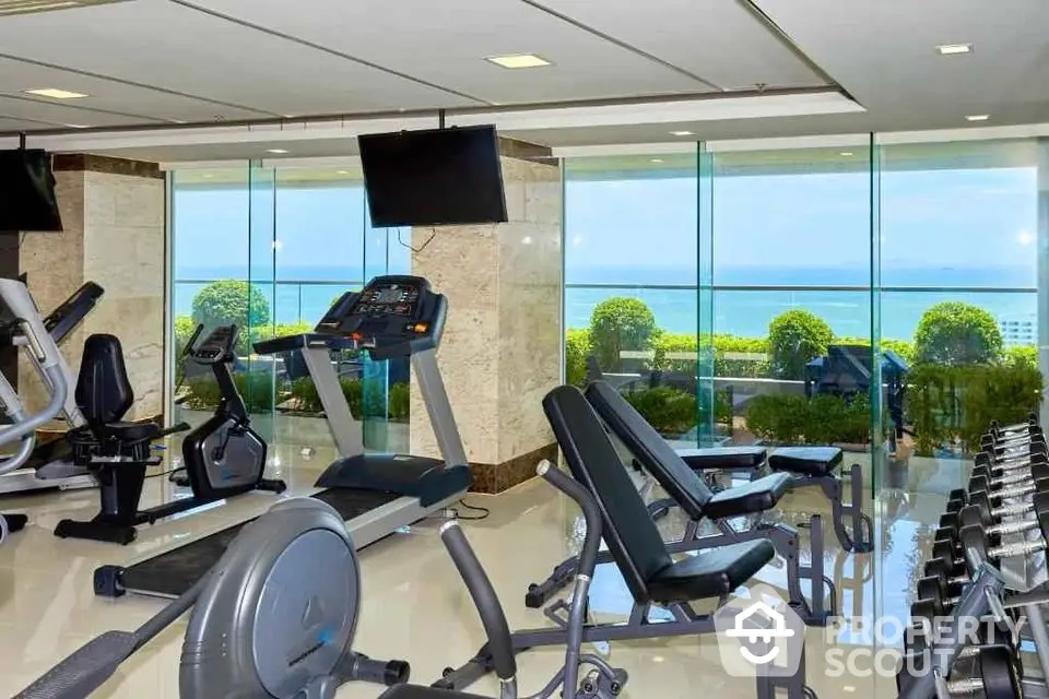 Luxurious gym with ocean view and modern fitness equipment