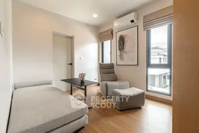 Modern living room with stylish furniture and large windows offering natural light.
