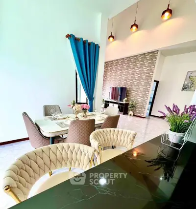 Elegant dining area with modern decor and stylish lighting in a spacious living room.
