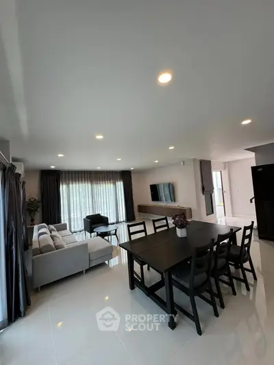 Spacious modern living and dining area with elegant furnishings and natural light.