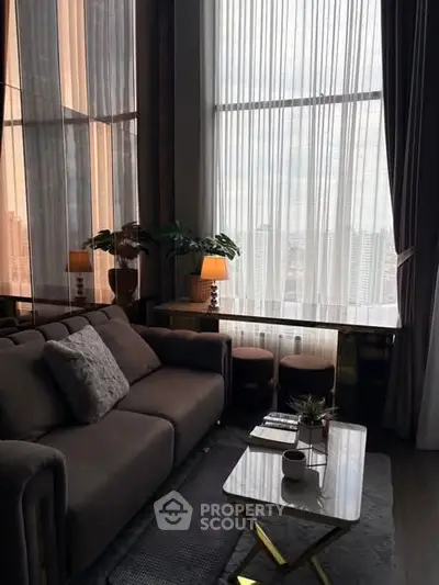 Luxurious living room with floor-to-ceiling windows and elegant decor