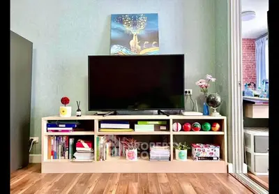 Stylish living room with modern TV stand and decor, showcasing a cozy and inviting atmosphere.