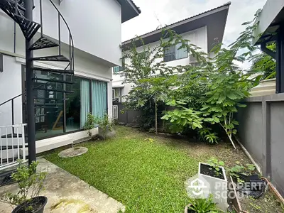 Charming garden view with spiral staircase in modern home exterior