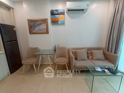 Modern living room with cozy sofa, glass table, and stylish decor in a contemporary apartment.