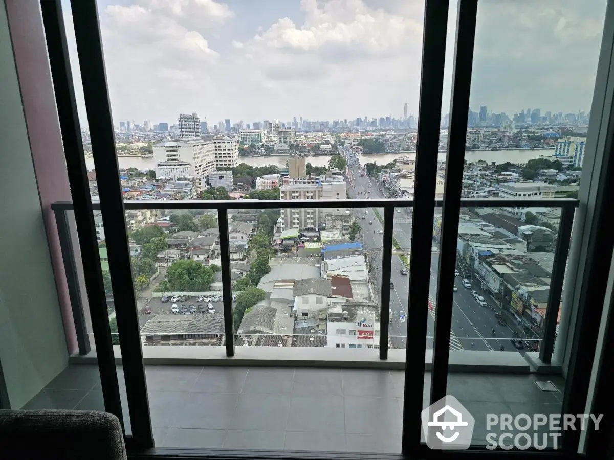 Stunning cityscape view from high-rise balcony with glass railing